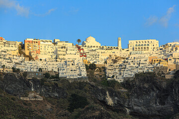 Naklejka premium Thira, Fira, Santorini, Greece. Aerial view of Santorini, Greek cathedral, white washed buildings and the Caldera