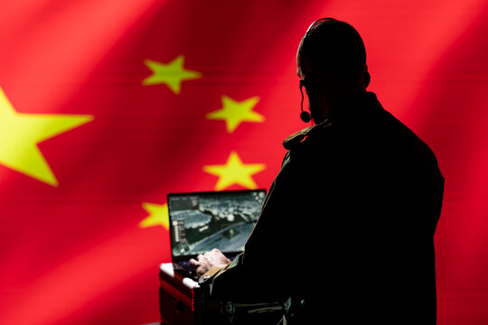 Chinese CCP agent combating organized crime and terrorism using detection system on laptop. China intelligence department officer protecting national sovereignty by tracking terrorists