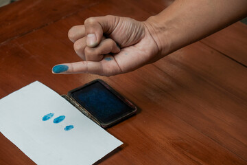Finger man dipped in purple ink marks after the general election. presidential election day. Pemilu...