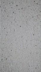 Close-up of textured surface with vertical lines.  Gray and white tones create a linear pattern, ideal for backgrounds or textures.