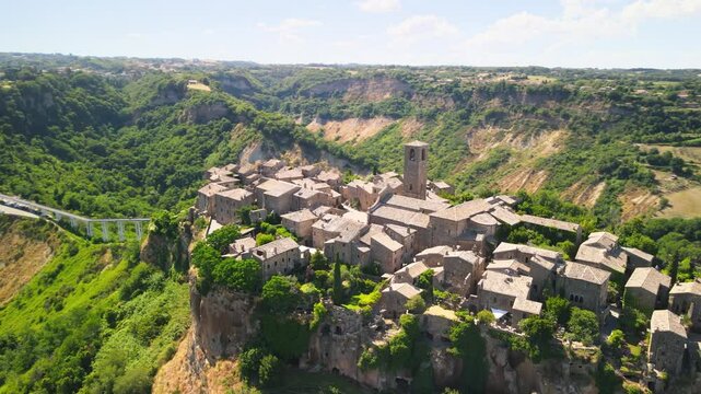 Panoramic aerial view of Civita di Bagnoregio from a flying drone around the medieval city, Italy