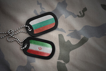 vintage army blank, dog tag with flag of bulgaria and iran on the khaki texture background....