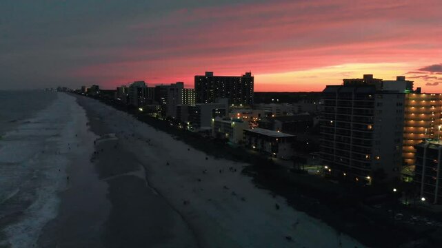 Aerial view of Myrtle Beach coastline and buildings from drone at sunset, South Carolina