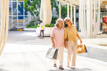 Happy Asian senior woman shopping at department store. Healthy elderly women friends enjoy and fun...
