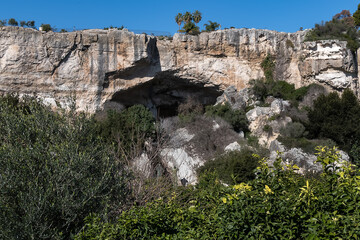 In north of Neapolis Archaeological Park is Paradise stone quarry (Latomia del Paradiso). Today it is a beautiful garden with Mediterranean vegetation and numerous caves. Syracuse, Sicily, Italy.