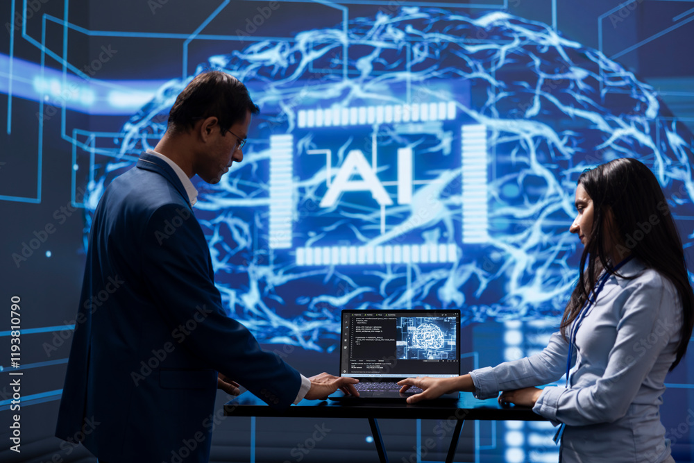 Poster engineer and coworker use ai cognitive computing to extract information from complex data on laptop.