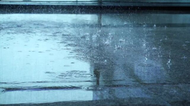 Capturing the beauty of summer rainstorm on a rainy day with close-up shots of raindrops on a smooth surface