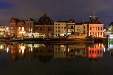Fototapeta premium Netherlands, Zuid Holland, Maassluis. Night and harbor boats and row houses.