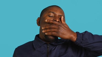 Portrait of security job employee yawning while at work detaining perpetrators, feeling tired....