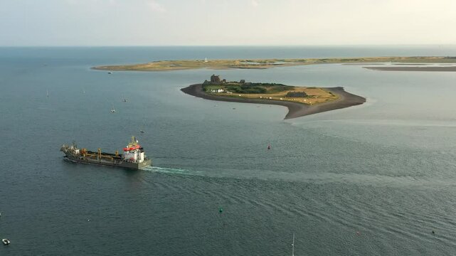 South across Walney Channel toward Piel Island and Walney Lighthouse from Roa Island. Cumbria, England. Video fly in