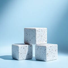 Minimalist Product Presentation Mockup with Three Geometric Blocks in Soft Blue Studio Setting