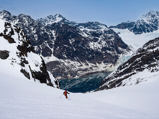 Svalbard, Norway. Solo skier having a powder run.
