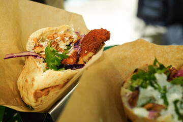 Pita sandwich with crispy chicken, cabbage and tomato