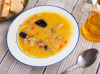 Nice plate of hot pea soup with smoked meat ready to eat