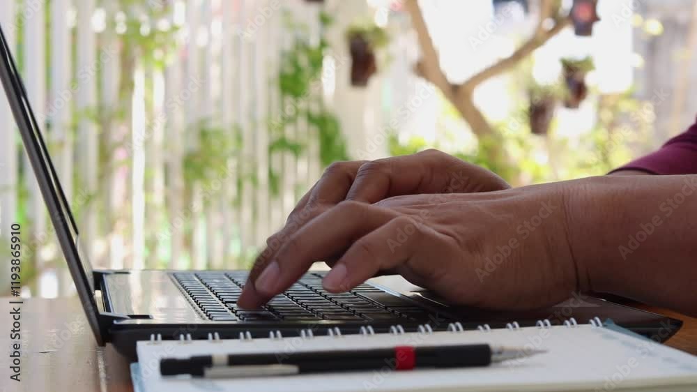 Aufkleber Close-up of the man's hand is typing on a laptop computer keyboard at home or in the office. He is working, sending messages, chatting, browsing the internet, and using social networking.