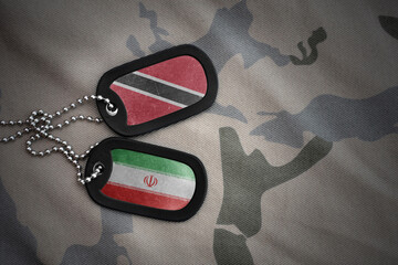 vintage army blank, dog tag with flag of trinidad and tobago and iran on the khaki texture...