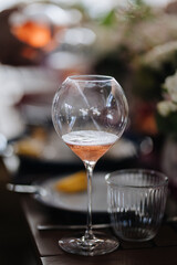 Half-filled wine glass with rose, capturing elegance and sophistication at a fine dining event