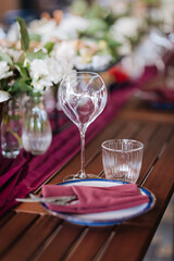 Elegant wine glass and water glass on a rustic table, perfect for fine dining and event settings