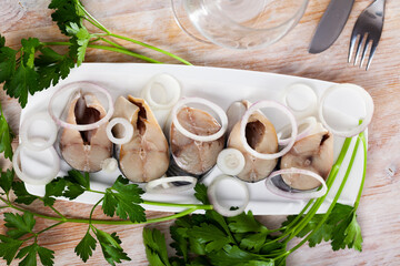 Image of sliced lightly salted mackerel fish served with onion and greens