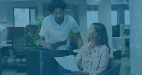 Image of globe and financial data processing over diverse business people in office