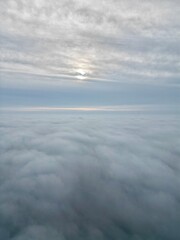 a view of the sun high above the clouds