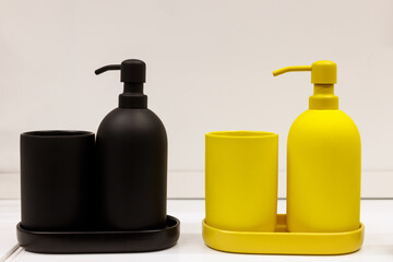 A set of blue and yellow liquid soap dispensers
