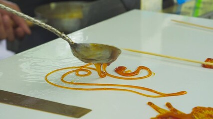 Mastering the art of intangible cultural heritage through animal sugar painting in traditional demonstrations