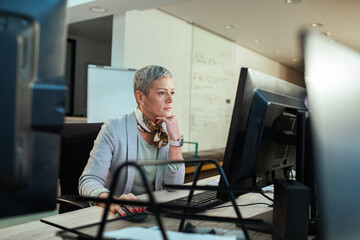 Focused businesswoman working on office computer