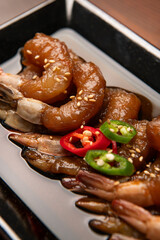 Raw shrimp and soy sauce on the plate