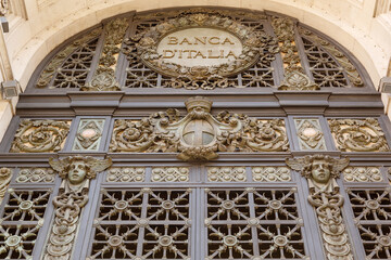 Details of the ornate front door metal grate of the Banca D’Italia building, Milan