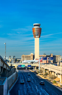 Phoenix, Arizona - January 4, 2025: Air Traffic Control Tower with American Airlines Airbus A319 at Phoenix Sky Harbor PHX airport in the United States