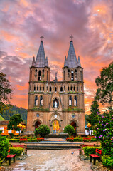 Obraz premium Minor Basilica of the Immaculate Conception in Jardin, Colombia with a dramatic sunrise sky