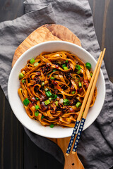 Shallot Chili Oil Noodles Served in a Ramen Bowl: Hot and spicy lo mein noodles topped with chili...