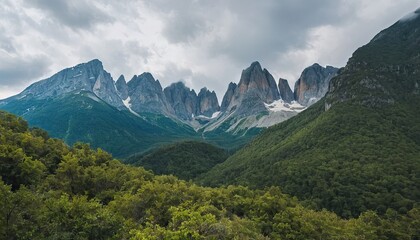 Fototapeta premium Wide angle panoramic view of the mountain peaks covered with snow SS8
