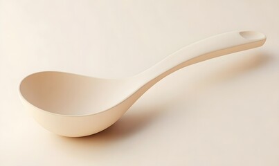 Beige plastic serving ladle on beige background.