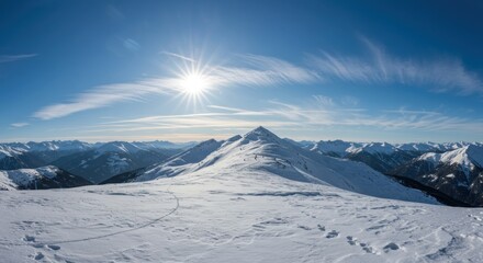 Snowy mountain peak, bright sun in clear blue sky, wispy clouds, winter landscape, crisp white snow, sunburst effect, panoramic view, serene