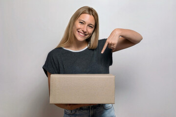 Joyful Female Highlighting the Box She’s Holding