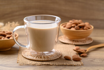 Almond milk in cup glass on wooden table, Alternative milk made from plant, non dairy