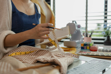 Design professional marking on fabric, designer working in the studio, tailor adjusts garment design on mannequin in workshop - fashion atelier, Woman measuring fabric in fashion design studio