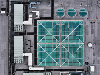 Commercial roof with blue glass windows and HVAC