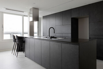 Black kitchen furniture creates a luxurious hotel-like kitchen interior