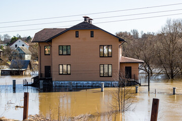 Houses in the village standing in the water during a strong flood of the river in spring
