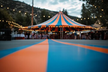 A blue and orange striped tent creates a festive atmosphere in an outdoor location, providing a colorful space for gatherings and celebrations