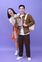 Two young Asian student on purple background