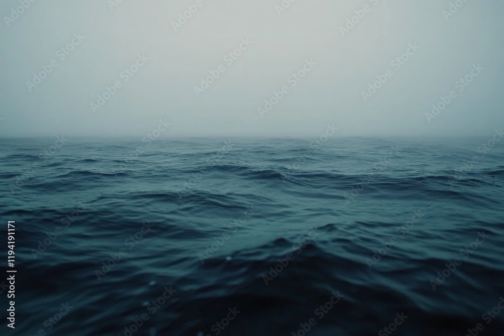 Poster a massive blue ocean wave rears up under a gray sky, capturing the raw power of nature with its text