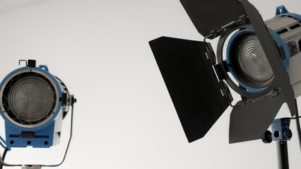 Spotlights off. Theatre lamp. Professional classic different type studio equipment on standby. Advertising illuminator rental background free space.