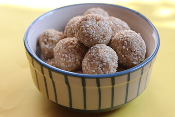 Til gul ladu or sesamum ladoo or sesame laduu, sweet balls made with sesame, peanuts and jaggery, Indian festival food