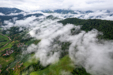 Landscape of Morning Mist with Mountain Layer. mountain ridge and clouds in rural jungle bush forest
