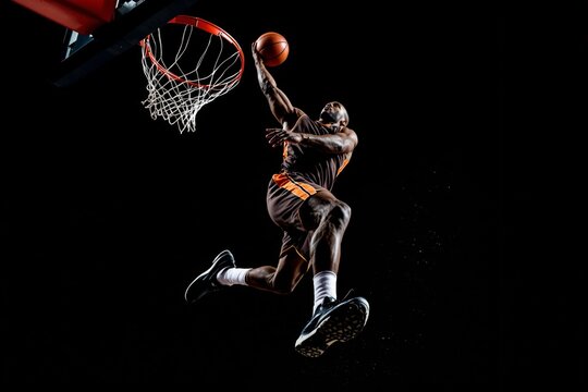 Basketball player in motion performing slam dunk, wearing dark uniform with vibrant stripes on abackground. Concept of athleticism. Ai generative