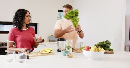 Preparing healthy smoothie, young multiracial couple chopping fruits and vegetables, at home